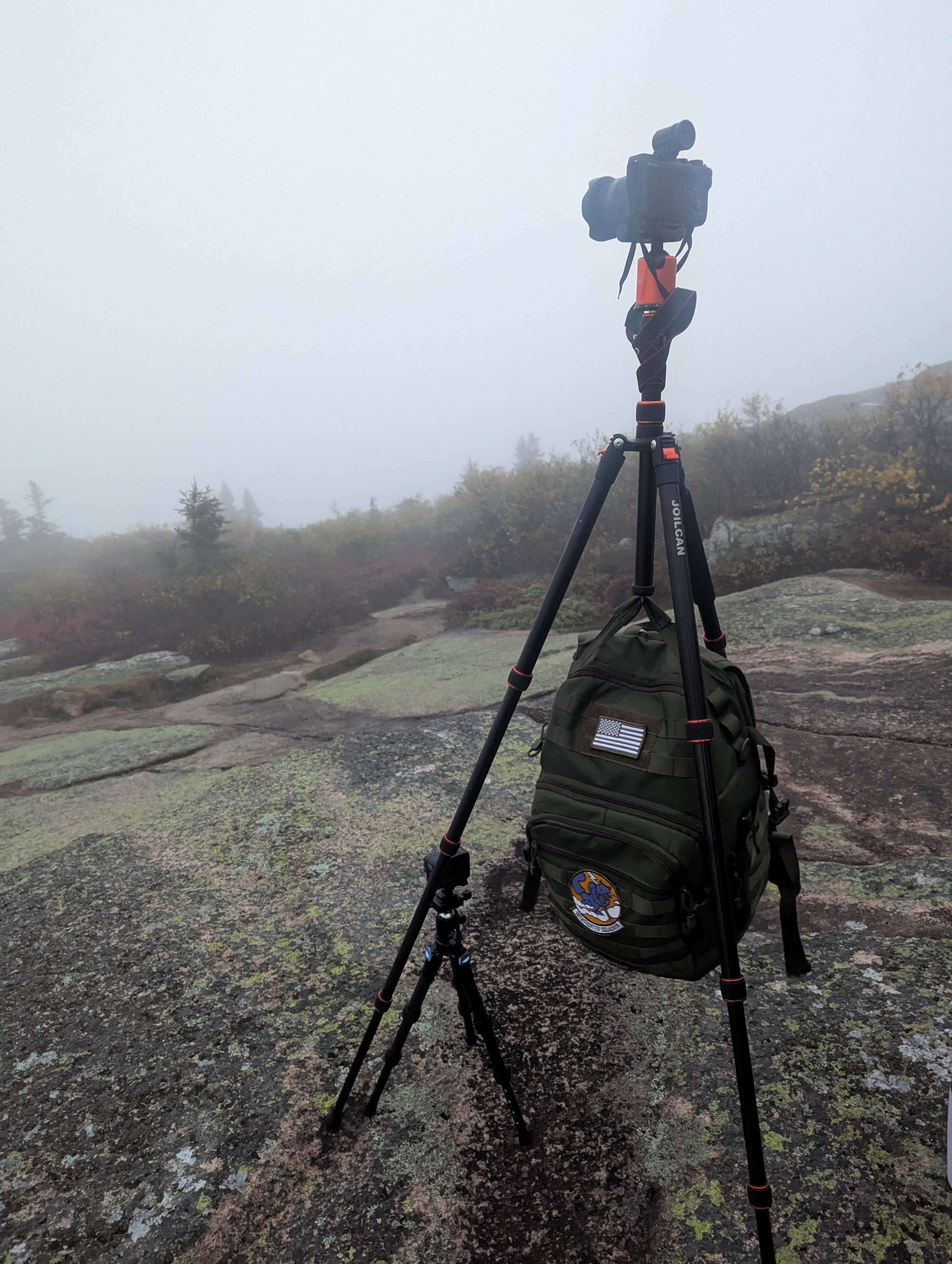 Tripod setup on Cadillac Mountain summit during a foggy sunrise in Acadia National Park